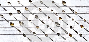 Vintage cutlery - spoons, forks and knives on an old wooden background