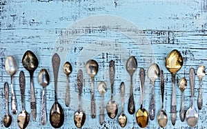 Vintage cutlery - spoons, forks and knives on an old wooden background