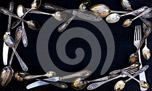 Vintage cutlery - spoons, forks and knives on an old wooden background