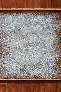 Vintage cutting board covered with flour. space for recipe menu text on old wooden background