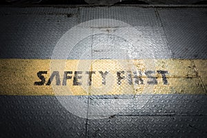 Vintage dark tone of Safety first sign on yellow line at metal