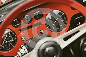 Vintage dashboard with various gauges on a retro car