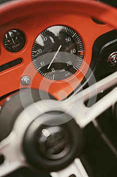 Vintage dashboard with various gauges on a retro car