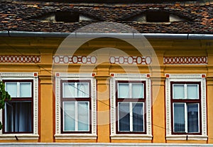 Vintage decorated faÃ§ade with eyes on the roof in Sibiu Romania