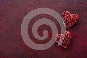 Vintage decorative hearts on the wooden board painted in dark-red with copy space for text. Flat lay.  Valentine`s day background