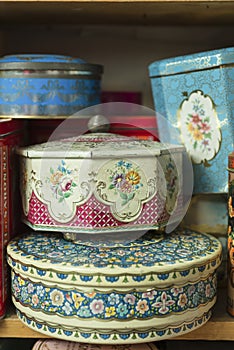 Vintage Decorative Tin Canisters on Wooden Shelf