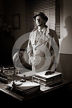 Vintage detective standing in his office