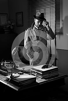 Vintage detective standing in his office