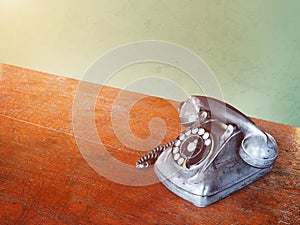 Vintage dial telephone on wooden brown table