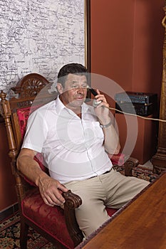 Vintage director, forties, man talking on a corded phone