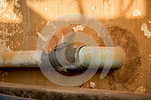 Vintage Dirty Plastic Water Faucet with PVC Valve - Old Concrete Texture