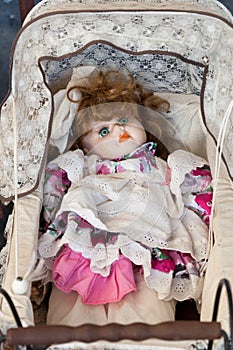 Vintage doll in cradle