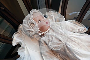 Vintage doll in cradle