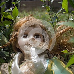 A vintage doll in the garden