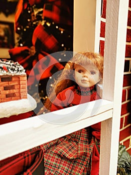 Vintage doll near the window Christmas decaration