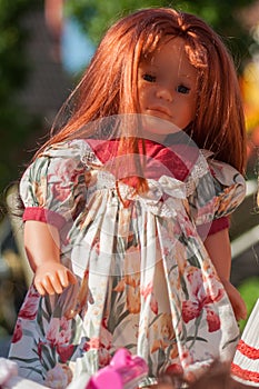 vintage dolls with red hairs and beautiful dress at flea market in the street