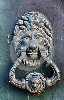 Vintage door knocker on green wooden door