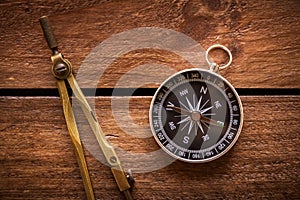 Vintage drawing and navigational Compass on a rustic wood board