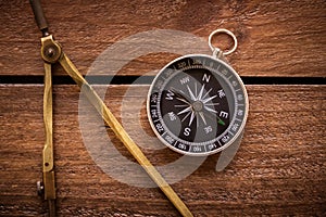 Vintage drawing and navigational Compass on a rustic wood board