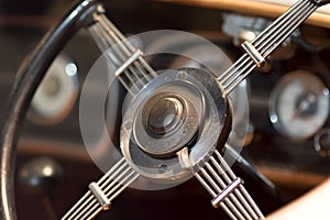 Vintage dual ratio car steering wheel close-up. History of driving