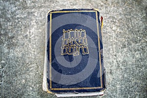 Vintage dusty Hebrew Bible book Tanakh Tanach on a on gray texture background, Israel