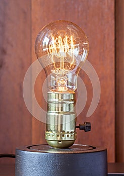 Vintage edison light bulb with wood background for hotel decorat