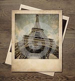 Vintage Eiffel tower instant pictures on wood background