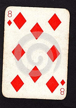 A vintage eight of diamonds playing card on a black background.