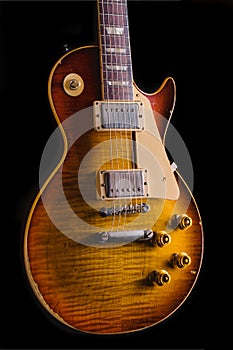 Vintage Electric Guitar with flamed maple top under arty lighting showing texture and detail