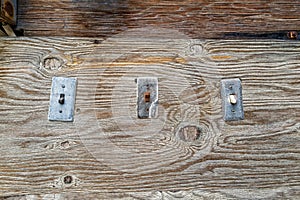 Vintage electrical switches haphazardly attached to a wood board photo