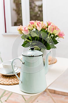 Vintage enamel tea pot pale blue with bouquete of pink roses