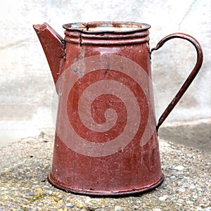 Vintage enameled kettle. Old enameled teapot of brown color.