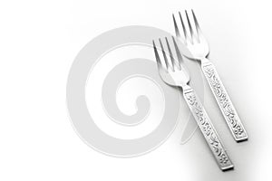 Vintage engraved silverware forks isolated on a white background