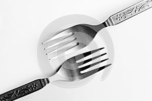 Vintage engraved silverware forks isolated on a white background