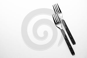Vintage engraved silverware forks isolated on a white background