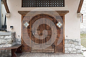 Vintage entrance door of european style building in Cortina d`Ampezzo, Italy