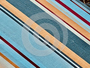 Vintage Fabric with Red, Blue, and Orange Stripes: A Symphony of Lines, Grooves, and Colors on White Material