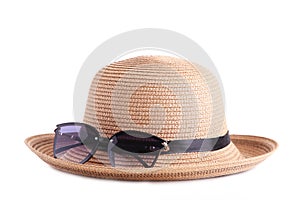 Vintage fabricate straw hat and sunglasses isolated on white background