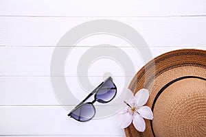 Vintage fabricate straw hat and sunglasses on white background photo