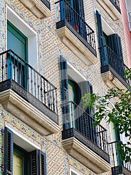 Vintage facade decorated with classical tiles on Fuencarral street, Chueca district, Madrid, Spain. Vertical photo photo