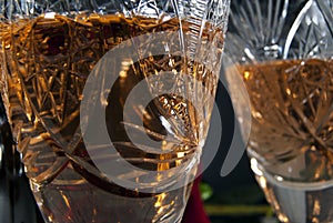 Vintage faceted crystal glass with white wine closeup