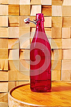 Vintage faceted medieval pink bottle of wine on a traditional winery table