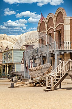 Vintage Far West town with saloon. Old wooden architecture in Wild West