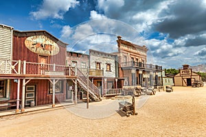 Vintage Far West town with saloon. Old wooden architecture in Wild West