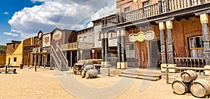 Vintage Far West town with saloon. Old wooden architecture in Wild West