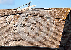 Vintage farm barn collapsing roof section