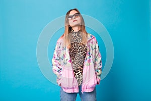 Vintage fashion look concept - pretty young woman wearing a retro jacket and leopard body on blue background