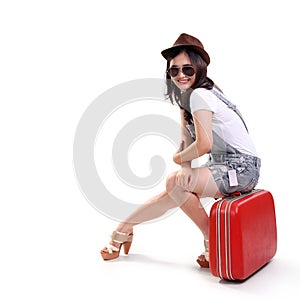 Vintage fashioned traveler on suitcase smiling