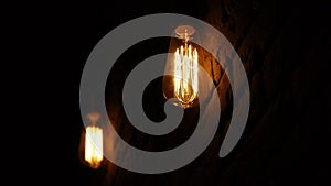 Vintage filament Edison light bulb. The lamps lights up in the dark. The incandescent lamp with a tungsten filament
