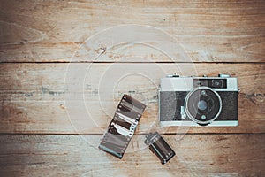 Vintage film camera on old wooden background